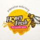 Logo Honey Fresh pour une marque de préparation de miels,avec une abeille avec un air espiègle qui tire la langue.